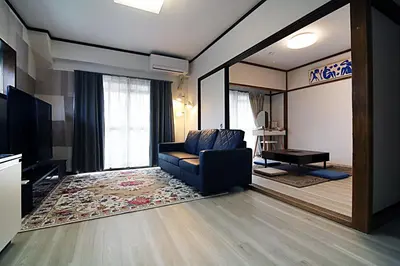 a living room with a couch and a television at HEISIEI HOUSE Shin-Ōkubo FREE WIFI in Tokyo
