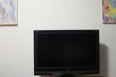 a flat screen tv sitting next to a wall at HEISIEI HOUSE Shin-Ōkubo FREE WIFI in Tokyo