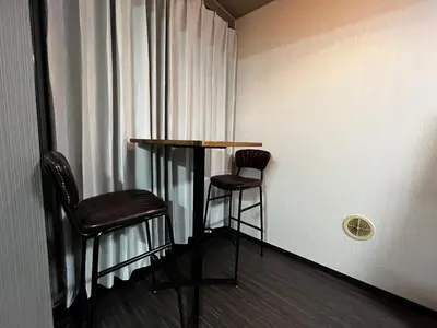 two chairs and a table in a room with a window at YOSHINO HOUSE!! Central Shinjuku Okubo Stay - Comfortable & Convenient in Tokyo
