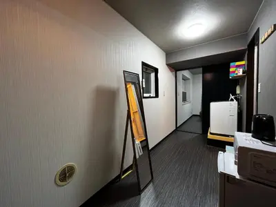 a room with a hallway with a mirror on the wall at YOSHINO HOUSE!! Central Shinjuku Okubo Stay - Comfortable & Convenient in Tokyo