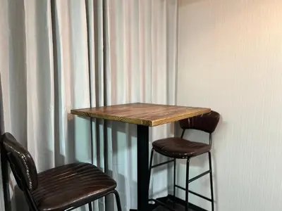 a table and two bar stools next to a curtain at YOSHINO HOUSE!! Central Shinjuku Okubo Stay - Comfortable & Convenient in Tokyo