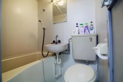 a bathroom with a sink and a toilet and a bath tub at YOSHINO HOUSE!! Central Shinjuku Okubo Stay - Comfortable & Convenient in Tokyo