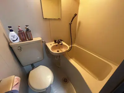 a small bathroom with a toilet and a sink at YOSHINO HOUSE!! Central Shinjuku Okubo Stay - Comfortable & Convenient in Tokyo