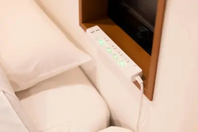 a wii remote control attached to a wall at SATELLITE HOTEL Roppongi \u30b5\u30c6\u30e9\u30a4\u30c8\u30db\u30c6\u30eb\u516d\u672c\u6728 in Tokyo