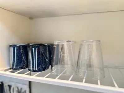 three vases sitting on a shelf in a kitchen at nestay apartment tokyo shinjuku in Tokyo