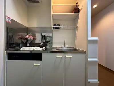 a kitchen with white cabinets and a sink at nestay apartment tokyo shinjuku in Tokyo
