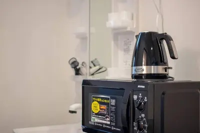 a coffee maker sitting on top of a microwave at Japanese Tradition Hotel Evergreen in Tokyo