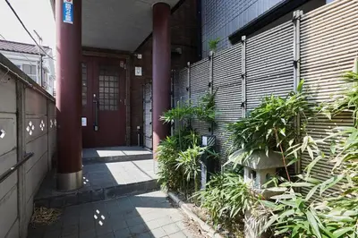 a hallway of a building with plants in front of it at Japanese Tradition Hotel Evergreen in Tokyo