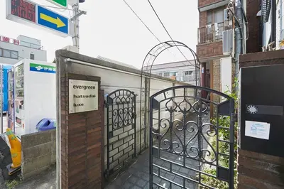 an entrance to a building with an iron gate at Japanese Tradition Hotel Evergreen in Tokyo