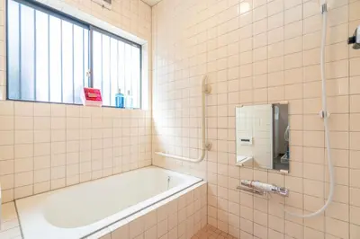a bathroom with a tub and a sink and a mirror at JR 66sqm 1F Family Suite 2LDK JR Koiwa-Keisei Koiwa-Asakusa-Oshiage-Shinjuku-Ueno in Tokyo
