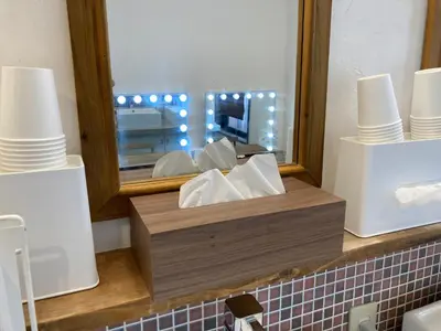a wooden box of tissues sitting on a counter with a mirror at Hostel Lodging Tokyo Ueno in Tokyo