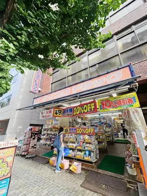 a woman is standing in front of a store at \u6b4c\u821e\u4f0e\u753a704 in Tokyo