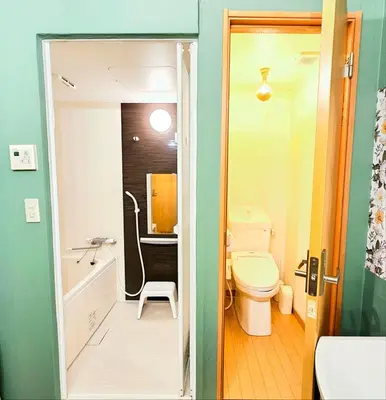 a bathroom with a toilet and a tub and a sink at ueno minowa401 in Tokyo