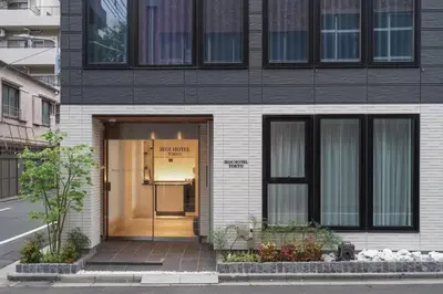 a black and white building with a glass door at Tokyo IKOI HOTEL\u30fc\u7dba\u9e97\u306a\u30db\u30c6\u30eb in Tokyo