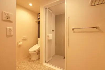 a bathroom with a toilet and a glass shower door at Tokyo IKOI HOTEL\u30fc\u7dba\u9e97\u306a\u30db\u30c6\u30eb in Tokyo
