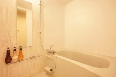 a white bath tub in a bathroom with a mirror at Tokyo IKOI HOTEL\u30fc\u7dba\u9e97\u306a\u30db\u30c6\u30eb in Tokyo