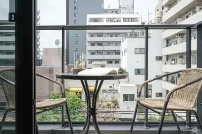 a table and chairs on a balcony with a view at Tokyo IKOI HOTEL\u30fc\u7dba\u9e97\u306a\u30db\u30c6\u30eb in Tokyo