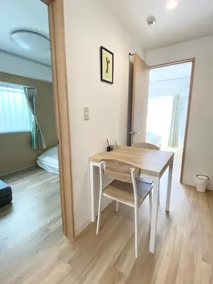 a dining room with a table and a bedroom at Ueno\u6b63\u548c\u30d3\u30eb in Tokyo