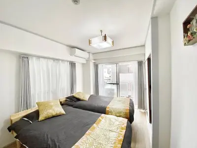 a bedroom with two beds and a window at Ueno\u6b63\u548c\u30d3\u30eb in Tokyo