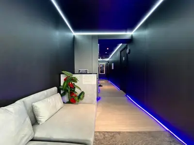 a long hallway with a couch and blue lights at Ueno\u6b63\u548c\u30d3\u30eb in Tokyo