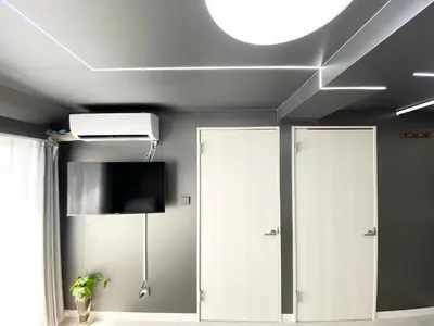 a room with two doors and a tv on the ceiling at Ueno\u6b63\u548c\u30d3\u30eb in Tokyo