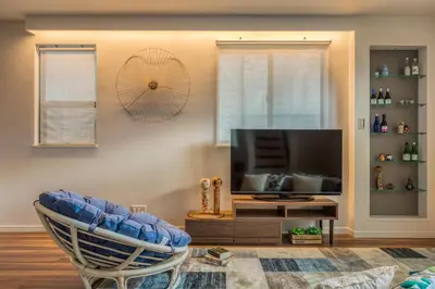 a living room with a chair and a television at self-check in-House,Ueno sky tree area, free wifi 3LDK in Tokyo