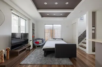 a bedroom with a bed and a flat screen tv at self-check in-House,Ueno sky tree area, free wifi 3LDK in Tokyo