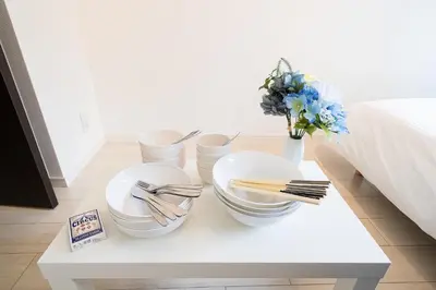 a white coffee table with plates and utensils on it at Square Shibuya in Tokyo