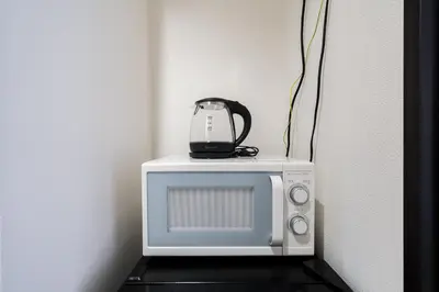a microwave with a tea kettle on top of it at Square Shibuya in Tokyo