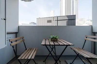a wooden table and two chairs on a balcony at Square Shibuya in Tokyo