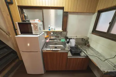 a small kitchen with a sink and a refrigerator at Sumida-ku - House - Vacation STAY 14512 in Tokyo