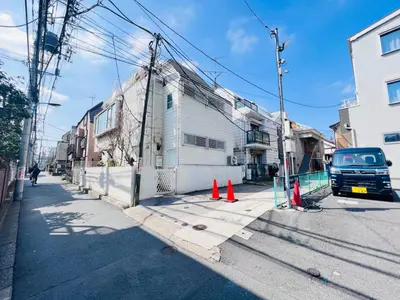 a street with orange cones in front of a building at OkuboZYZ SJ0244 in Tokyo