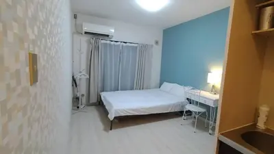 a small room with a bed and a desk and a sink at OkuboZYZ SJ0244 in Tokyo