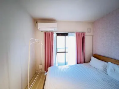 a small bedroom with a bed and a window at OkuboZYZ SJ0244 in Tokyo