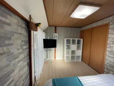 a bedroom with a brick wall and a tv at Nishi-Shinjuku 3LDK SJ0243 in Tokyo