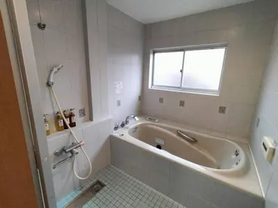 a bathroom with a bath tub and a window at Nishi-Shinjuku 3LDK SJ0243 in Tokyo