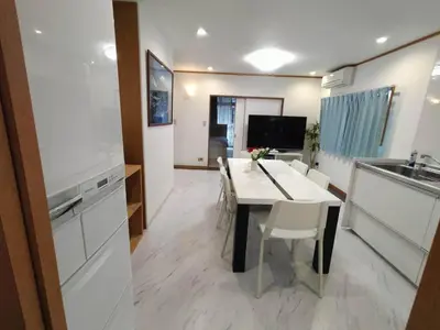 a kitchen and dining room with a table and chairs at Nishi-Shinjuku 3LDK SJ0243 in Tokyo