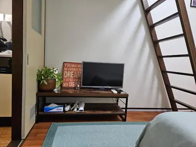 a television sitting on a table in a room at Shibuya SG House Free Wifi in Tokyo