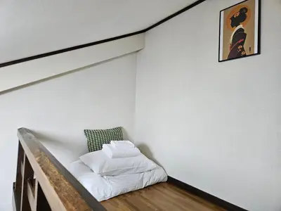a room with a bed in the corner of a wall at Shibuya SG House Free Wifi in Tokyo