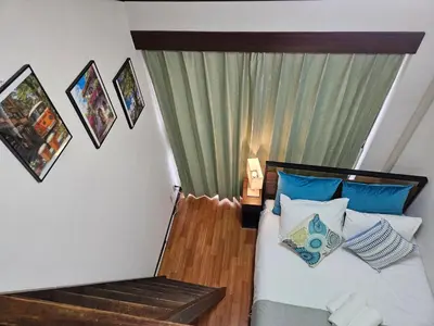 a bedroom with a bed with blue and white pillows at Shibuya SG House Free Wifi in Tokyo