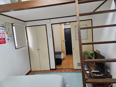 a bedroom with a bunk bed and a ladder at Shibuya SG House Free Wifi in Tokyo