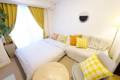 a small room with two beds and a couch at SQUARE SHIBUAYA 403 in Tokyo