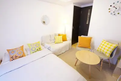 a bedroom with a bed and a couch and a table at SQUARE SHIBUAYA 403 in Tokyo