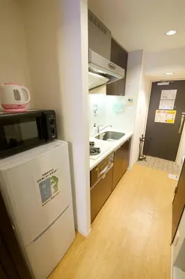 a small kitchen with a sink and a refrigerator at SQUARE SHIBUAYA 403 in Tokyo