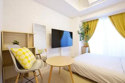 a bedroom with a bed and a table and a tv at SQUARE SHIBUAYA 403 in Tokyo