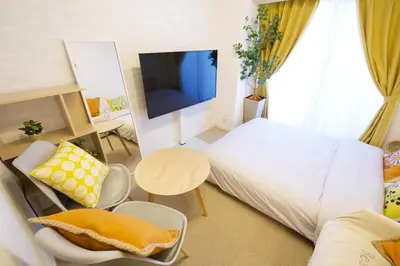 a small room with a bed and a tv at SQUARE SHIBUAYA 403 in Tokyo