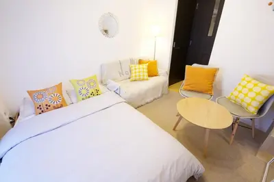 a bedroom with a bed and a table and a couch at SQUARE SHIBUAYA 403 in Tokyo