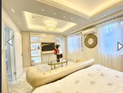a bedroom with a large bed and a table at Reimi Mondo9 in Tokyo