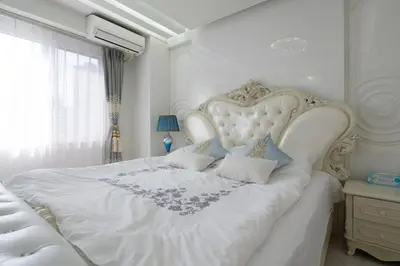a white bed with a white headboard in a bedroom at Reimi Mondo9 in Tokyo