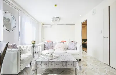 a white living room with a white couch and a table at Reimi Mondo9 in Tokyo